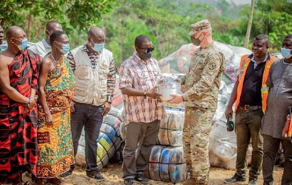 US Army Major Jarrod Simek of the Office of Security Cooperation presenting the items to the people