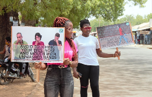 Some Members Of The Sound Mind Project Displaying Placards Along A Popular Street In Navrongo