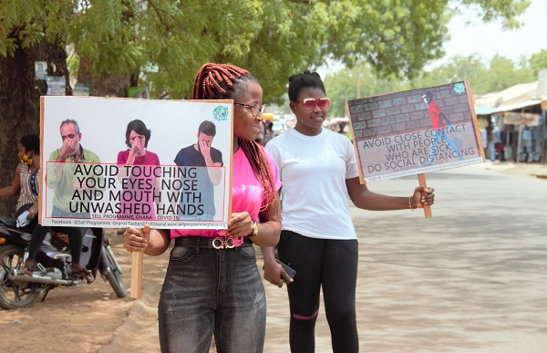 Some members of the Sound Mind Project displaying placards along a popular street in Navrongo