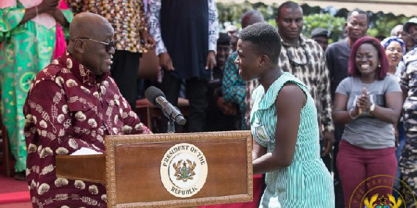 President Nana Addo Dankwa Akufo-Addo interacting with a beneficiary of the Free SHS policy