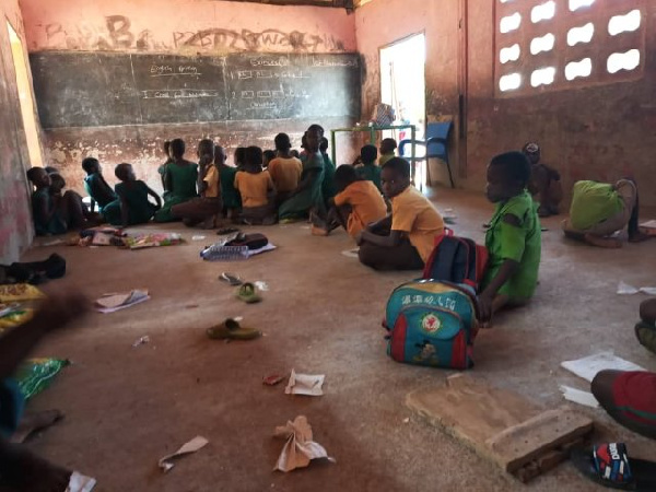 File photo of some pupil sitting on the floor during lesson hours