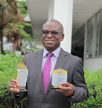 Paul Asare Ansah poses with his awards