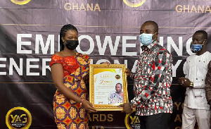 Mr. Francis Owusu-Akyaw receiving his citation from a member of the Youth Awards Ghana (YAG)