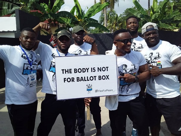 Some the bodybuilders holding a placard