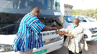 Upper West Regional Minister Dr Bin Salih  making a presentation of one of the buses