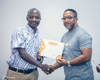 Dr. David Okyere, Head of Agency Banking presents certificate to Patrick Amankwah Arthur