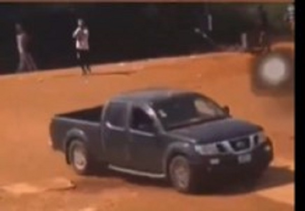 A man shooting at a vehicle during the clash