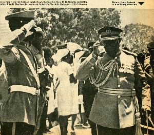 A newspaper clipping shows Gen Ankrah taking a salute from another uniformed man