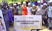 Ja Rule (in white) cutting sod for the construction of the classroom block