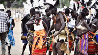 A dance troupe performs the Acholi Otole war dance during a cultural festival in Gulu