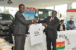 GOC President, Ben Nunoo Mensah presenting a shirt to a rep of Toyota Ghana