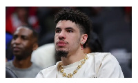 LaMelo Ball looks on from the bench during the first quarter of the Charlotte Hornets' game against