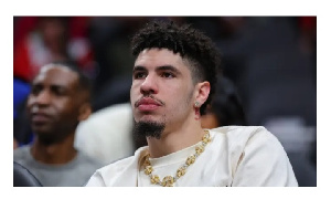 LaMelo Ball looks on from the bench during the first quarter of the Charlotte Hornets' game against