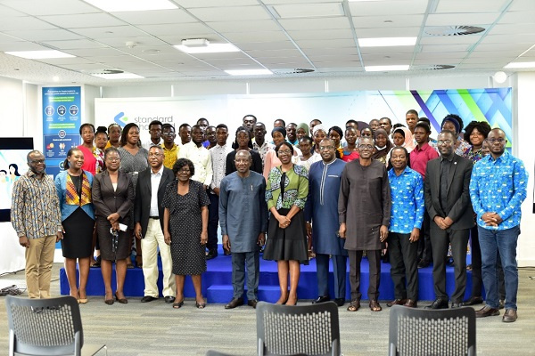 Standard Chartered executives in a photo with the students