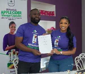 Andrew Kojo Kyere,MD of Drews Pharmacy with Serwaa Amihere, with the agreement signed