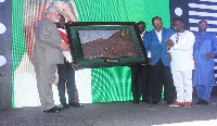 Former President Jerry John Rawlings (in an ash apparel) receiving his award