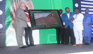 Former President Jerry John Rawlings (in an ash apparel) receiving his award