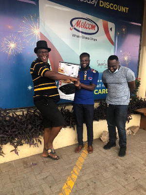 Mr. Jeremiah Lamptey (left) excited after shopping with the gift voucher he received from MTN