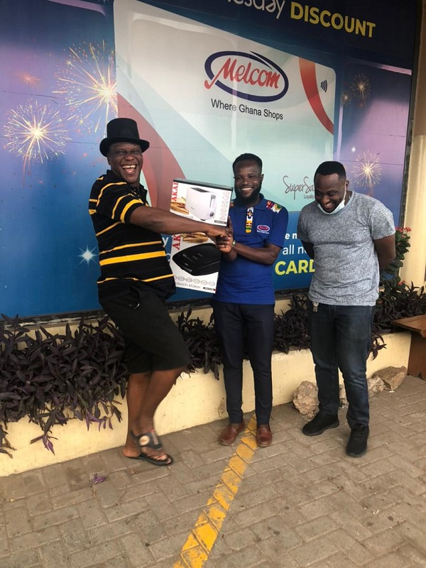 Mr. Jeremiah Lamptey (left) excited after shopping with the gift voucher he received from MTN