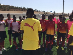 Players of Ghana's Black Maidens paying attention to their coach Yusif Basigi