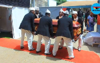 Pallbearers carry the remains of Wili Roi