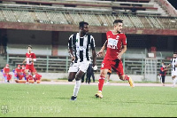 Ghana international Daniel Lomotey [in black and white jersey]