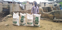 Aduni Achana with the donated bags of fertilisers