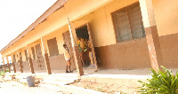 Students stand in the doorway of a classroom