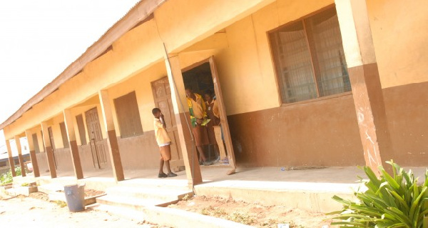 Students stand in the doorway of a classroom