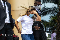 Aisha Huang (middle) being accompanied by two security officials