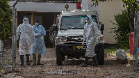 Medical personnel are seen at an ambulance outside the main COVID-19 treatment center