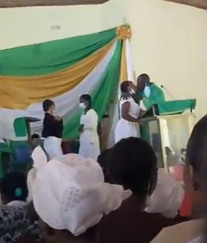 Rev. Obeng Larbi kissing a student at the  St Monica's College of Education