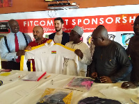 Alhaji Grusah, Kudjoe Finaoo, Frank Nelson and reps from Fitcom displaying the jersey