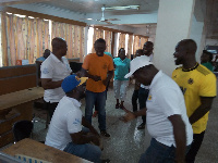 Some staff of GNA singing, drumming and dancing after they return from the Black Star square