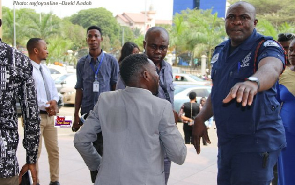 Police in a confrontation with a journalist