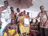 Veteran actor, David Dontoh (standing) presents a citation to Nana Kwasi Akuffo III