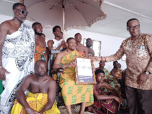 Veteran actor, David Dontoh (standing) presents a citation to Nana Kwasi Akuffo III