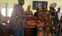 Alhaji Habib Iddrisu (left)handing the money to one of the beneficiary women