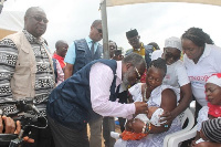 Dr Nsiah-Asare (second from left) administring the polio vacine to a baby .Photo;Mercy Amparbeng