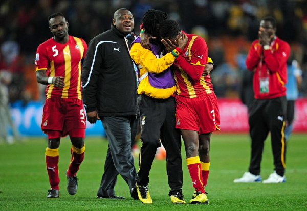 A file photo of Derek Boateng consoling Asamoah Gyan