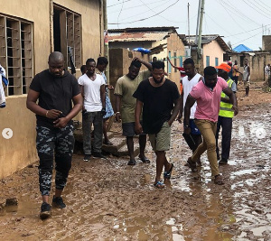 John Dumelo with others during his visit to some affected floods victims