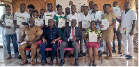 Officials in a pose with awardees