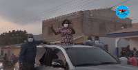 Prof Naana Opoku-Agyemang waving at some residents of Dodowa during her tour