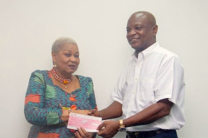 Togbe Afede XIV presents the cheque Madam Joyce Aryee