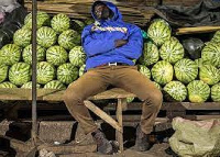 A vendor sleeps in a Ugandan market because of COVID-19 restrictions