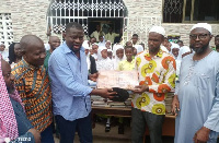 MP Frank Annoh-Dompreh (middle) makes the donation to a local school