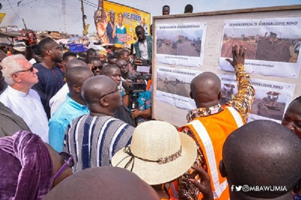 Vice President Dr Bawumia (in smock) being briefed on the Agbogbloshie road project during his visit