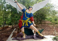 A Caucasian angel defeating a dark-skinned devil