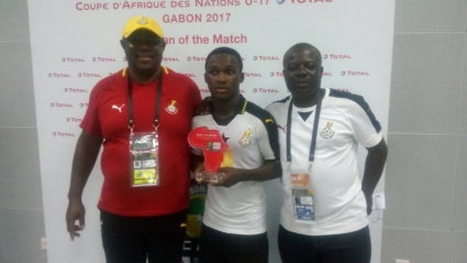 Emmanuel Toku (middle) with some officials after the match