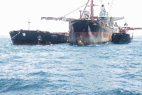 The Ship being loaded with manganese from the shuttle ship (right)